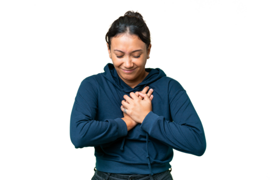 Young Uruguayan woman over isolated chroma key background having a pain in the heart