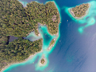 Aerial view of picturesque forested islands surrounded by turquoise waters.
