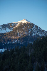 Fototapeta premium A snow-capped mountain peak at sunset.