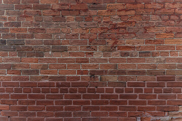 Fototapeta premium abstract background of an old red brick wall close up