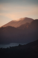 A serene mountain silhouette at dusk.