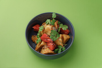 warm salad with fried eggplants on a green background