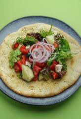 pita with greek salad and olive oil.