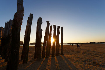 An idyllic beach scene featuring a picturesque view of a golden sunset in Saint-Malo .