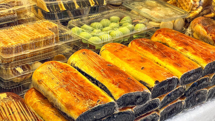 Assortment of fresh pastry and sweets displayed at a market stall, perfect for holiday celebrations or festive gatherings