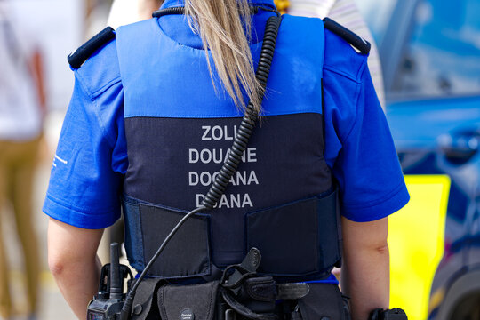 Swiss Z&uuml;rich Kloten Airport with rear view of back of female customs officer on a sunny late summer day. Photo taken September 1st, 2023, Kloten, Canton Z&uuml;rich, Switzerland.