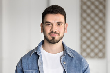 Positive handsome young Middle Eastern entrepreneur man in casual cloth head shot. Front portrait...