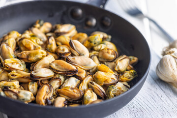 Fototapeta premium Shelled mussels meat in pan on white table