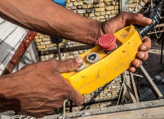 Hands Holding Yellow Construction Remote Control
