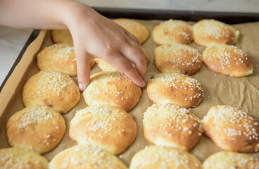Homemade cookies on dripping pan. Hand takes