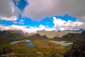 Lakes on the mountain tops and partly cloudy sky with mountain ranges