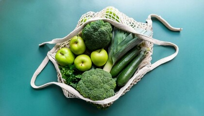 fresh green produce in reusable shopping bag top down view