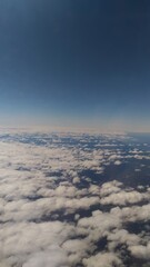 A bird's-eye view of the earth.  View of the ground from the plane. a landscape partially obscured by clouds. A landscape with an atmosphere of tranquility.