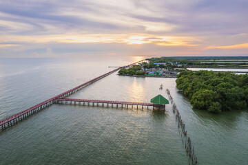 Fototapeta premium Colorful sunset on the sea at Red Bridge, Samut Sakhon province, Thailand.