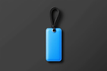 Fototapeta premium A vibrant blue luggage tag on a sleek black surface, showcasing a modern and stylish design.
