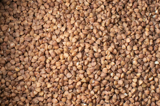 Close-up of raw buckwheat grains, highlighting healthy gluten-free dietary options and sustainable food trends for a nutritious lifestyle