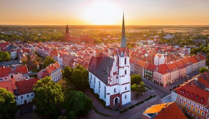 aerial high angle view of the parish of st john the baptist and old town buildings at sunset...