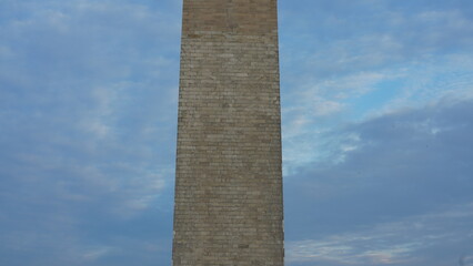 The monument tower view with the sunset sky as background in Washington DC
