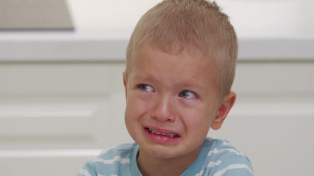 3-year-old child little boy crying with sad face closeup