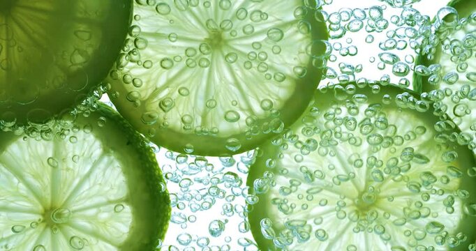 Lime Slices falling deeply under water. Shot on super slow motion camera 1000 fps.