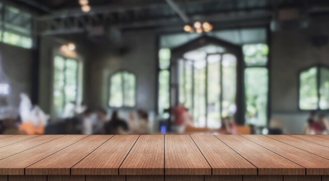 Empty wooden table top with lights bokeh on blur restaurant background.