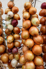 Onion bunches in open air market stall. Sao Paulo, Brazil