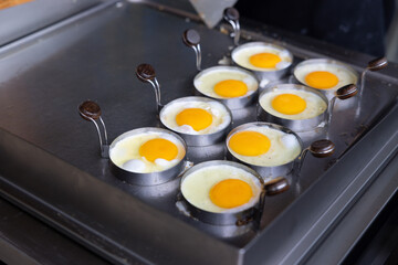 A pan of eggs is being cooked on a stove.