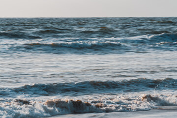 Dramatic seascape, abstract. Stormy Pacific ocean, and clear sky in the background, motion blur