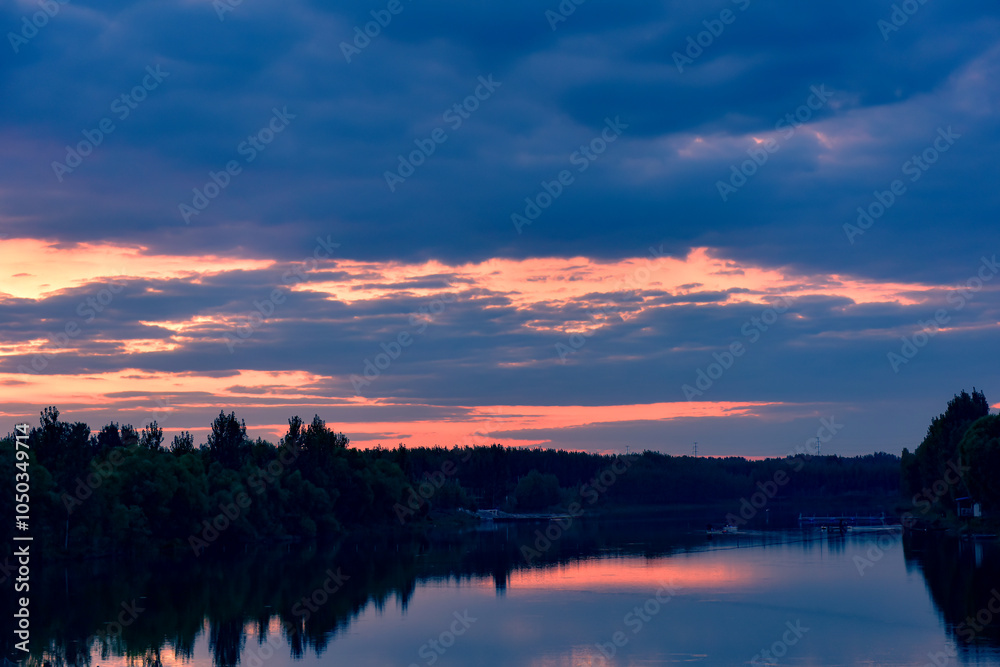 Wall mural the sunset background creates a beautiful scenery with the suspension bridge and river