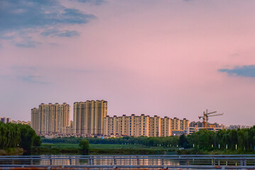 The sunset background creates a beautiful scenery with the suspension bridge and river