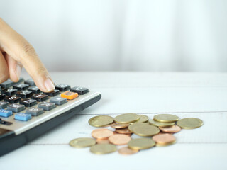 Hand counting money and pressing calculator on white background. Finance business concept. Copy...