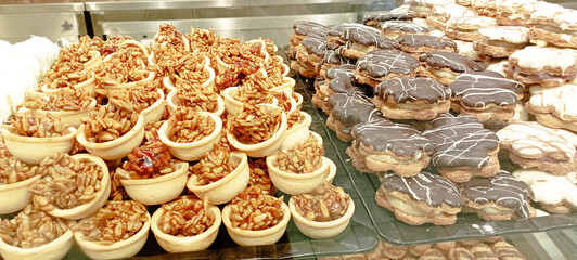 Fototapeta premium Dessert table with all kinds snacks on light background. Candy bar. Celebration concept. Top view, flat lay, panorama