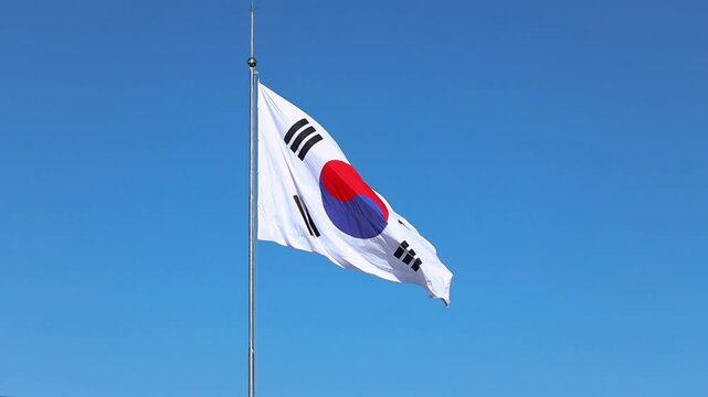 South Korean flag waving on the wind against blue sky