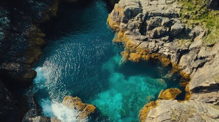 Obraz premium Aerial shot of the Fairy Pools on a sunny day, with the turquoise waters contrasting the rocky Scottish Highlands. No people included.