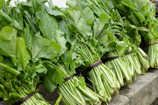 Fresh organic turnip greens sitting on a market stall at farmers' market in Galicia, Spain