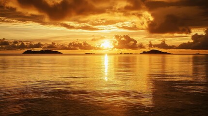 Fototapeta premium Sunset over the Mamanuca Islands, Fiji, with a golden sky reflecting on the calm, crystal-clear waters. No people included.