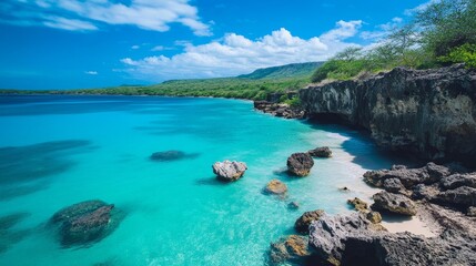 A stunning beach with crystal clear turquoise water, a rocky coastline, lush greenery and a blue sky with clouds. This tranquil paradise offers a perfect getaway for relaxation and adventure.