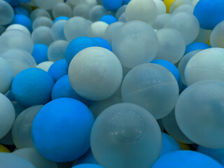 A close-up view of vibrant blue, white, and transparent glass balls captures a beautiful blend of colors and textures.