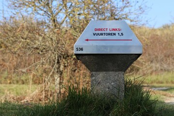 Low road sign in the Netherlands (for bicyles). This sign points towards the lighthouse (on the island Schiermonnikoog).