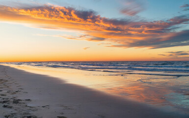 The sky has a gradient of orange, pink, and blue hues