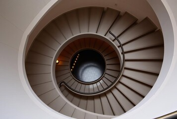 Fototapeta premium – A spiral staircase viewed from above creating the number's c