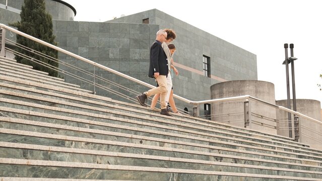 Business people discussing while descending stairs in city