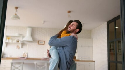 Joyful family Caucasian girl child running to happy father man guy male pick up little kid dad parent holding daughter smiling laugh spinning hugging cuddling embrace at home cheerful meeting weekend