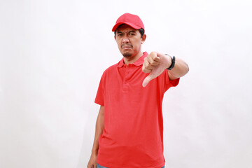 Professional dissatisfied delivery employee man with red cap t-shirt uniform work as dealer courier...
