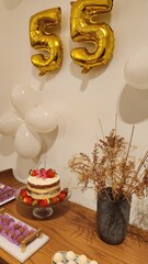 woman's 55th birthday, with sweets and decoration