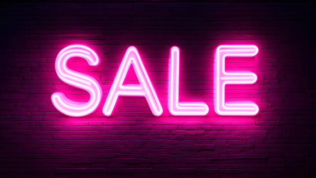 Pink neon Sale sign on black brick wall background.
