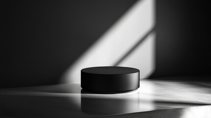 A sleek product packaging mockup sits on a reflective surface, dramatically lit to enhance shadows