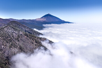 A volcano peaking out of the clouds in Tenerife, Spain