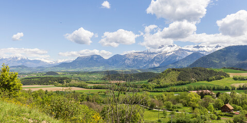 Obraz premium Landscape with scenic view of surroundings picturesque village Saint Maurice en Trieves in Auvergne Rhone region in France with Alpes mountains in the background