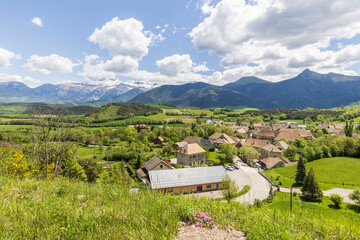 Landscape with scenic view of picturesque village Saint Maurice en Trieves in Auvergne Rhone region in France with Alpes mountains in the background